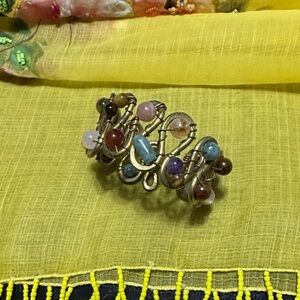 Multicoloured gemstones in brass bangle handmade by an artisan